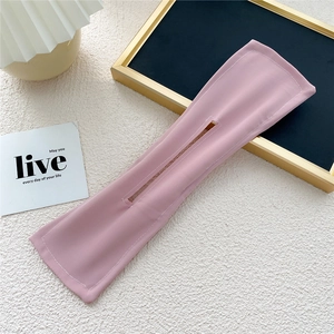 Detail of pink fabric hair bun maker tool with internal wire and stitching details