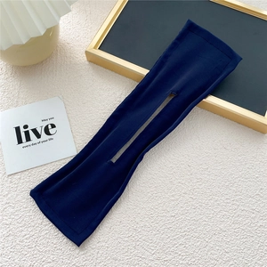 Detail of a dark blue fabric deft bun hair maker tool with center opening slot
