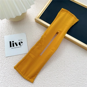 Detail of a bright yellow fabric deft bun hair maker with reinforced edge stitching