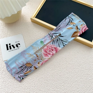 Detail of light blue floral chiffon hair bun maker with elegant pink rose patterns
