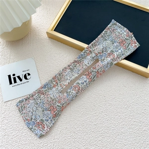 Detail of floral fabric hair bun maker with a flexible wire core and central opening