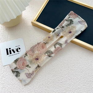 Detailed view of floral fabric bun maker with delicate pink roses and center opening