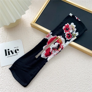 Floral print hair bun maker with inner wire shown in a lifestyle decorative setting