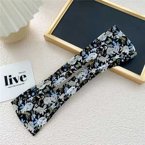 Detail view of the floral fabric pattern and center slot of this lazy hair curler tool