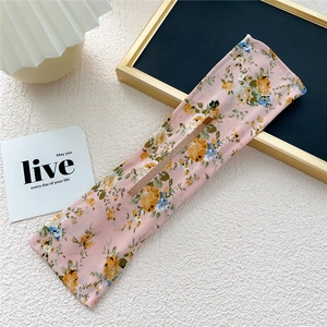 Detail of pink floral fabric hair bun maker with inner wire for elegant hair styling