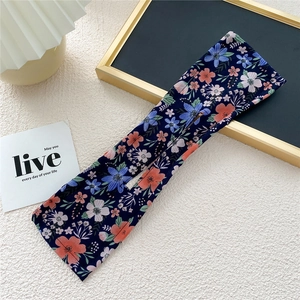 Close-up of a navy blue floral deft bun maker tool with internal wire for hair styling