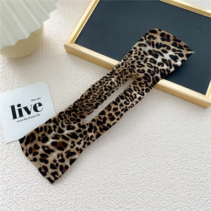 Detail of leopard print hair bun maker showing flexible fabric and hollow structure