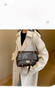 Macro detail of brown quilted leather texture and gold twist-lock on a shoulder bag