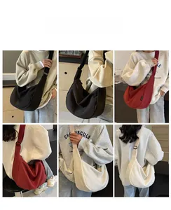 Detailed views of high-capacity canvas crescent bags in black, red, and off-white colors