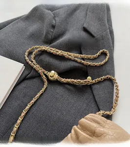 Detail of beige pleated cloud bag featuring golden adjustable ball chain and quilted texture
