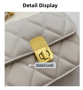 Detail of light beige quilted leather bag showing refined golden hardware lock