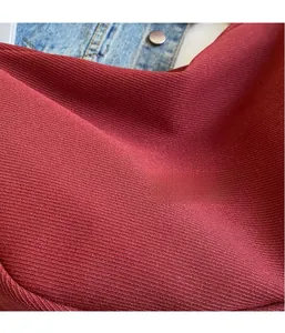 Close-up of dark red ribbed knit fabric texture on a large canvas dumpling bag