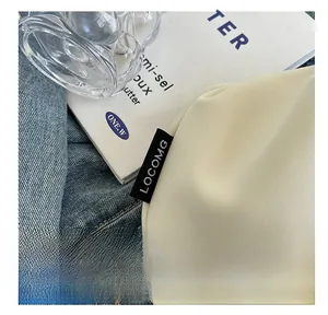 Close-up of off-white Oxford fabric bag showing diagonal texture and brand label