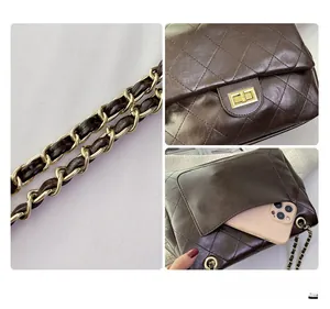 Detail view of brown quilted crossbody bag with metal chain strap and phone pocket