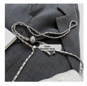 Macro shot of white quilted leather texture and adjustable silver chain strap