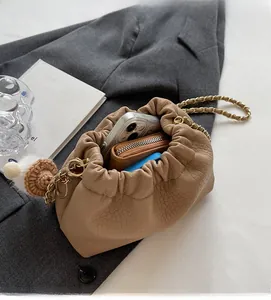 Macro shot of spacious inner compartment of the beige ruched cloud bag with essentials