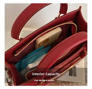 Internal capacity of dark red lychee leather wedding handbag with gold zipper detail