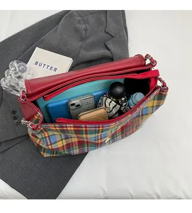 Spacious interior of a tartan tote bag holding a tablet, umbrella, and phone in a lifestyle setting