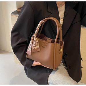 Brown lychee leather bucket bag with decorative plaid scarf and gold-tone hardware detail