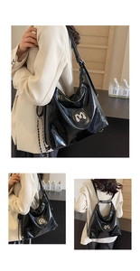 Detail of black Hobo tote featuring glossy pleated texture and silver metal M logo