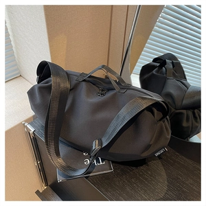 Close-up of waterproof Oxford cloth duffel bag with dual handles and brand label