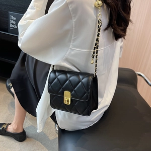 Elegant black quilted crossbody bag with gold chain strap and metal lock closure