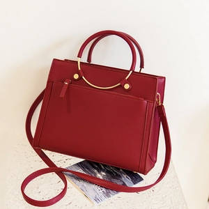 Elegant wine red leather bridal handbag with dual handles and荔枝 grain texture