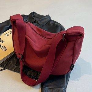 Burgundy canvas crescent crossbody bag in high-quality textured minimalist design