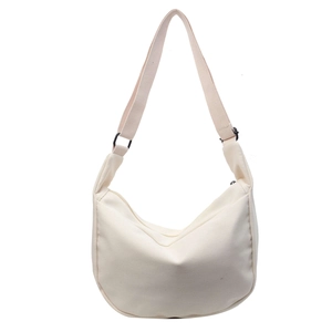 Minimalist off-white canvas half-moon crossbody bag with adjustable strap on white background