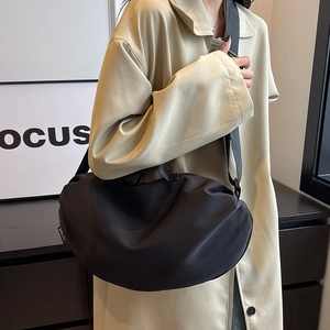 Large black nylon crescent hobo bag with adjustable wide strap shown on a model