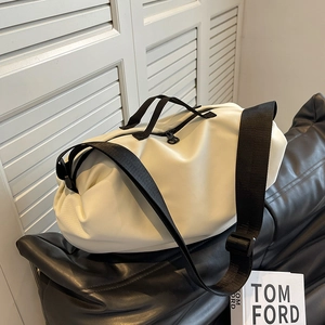 Chic beige oxford dumpling bag with wide black strap for versatile daily use