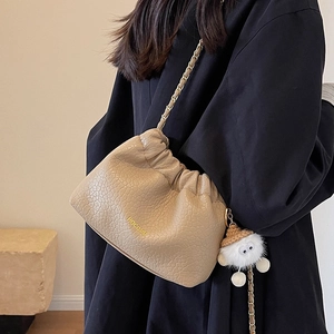 Beige pleated cloud bag with chain strap and cute plush monster pendant for women