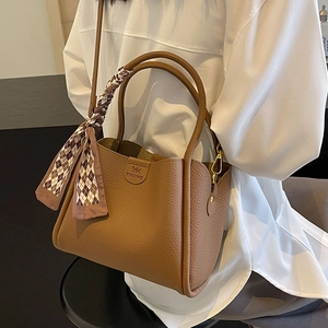 Brown litchi grain bucket bag with round handles, silk scarf detail and shoulder strap