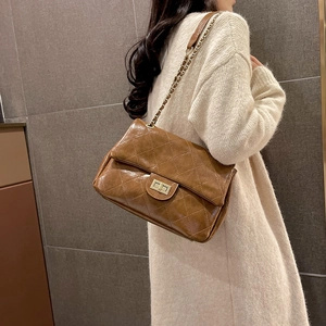 Brown quilted chain shoulder bag in oil wax leather finish with gold hardware