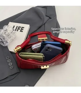 Internal view of a red patent leather handbag showing spacious capacity and zip pocket