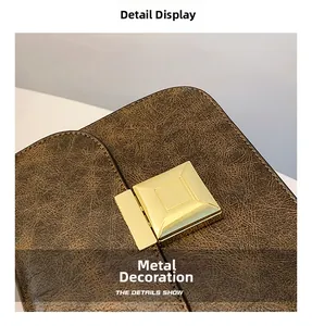 Macro shot of a square gold metal lock on a brown vintage faux leather handbag detail
