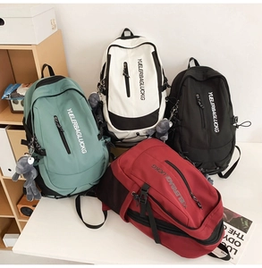 Detail view of large capacity school backpacks in green, white, black and red colors