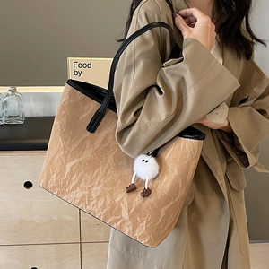 Minimalist large brown tote bag with black leather straps and plush charm for women