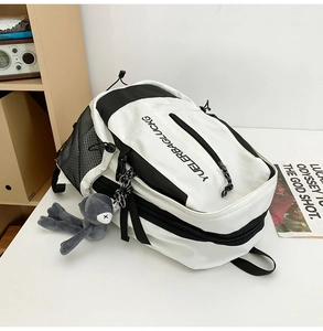 Detail view of large capacity black and white backpack with plush rabbit pendant