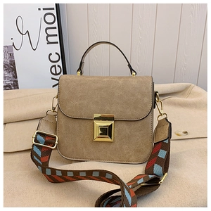Detail of vintage tan square crossbody bag with textured faux leather and jacquard strap
