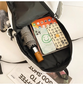 Large capacity backpack interior showing space for tablet, umbrella and phones