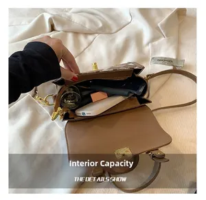 Detail view of small square bag interior showing multiple compartments and capacity