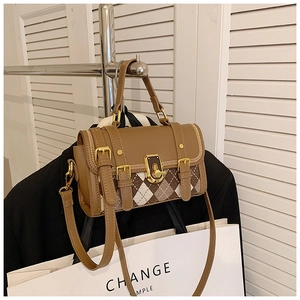 Detail of vintage brown argyle pattern crossbody bag with golden turn-lock closure