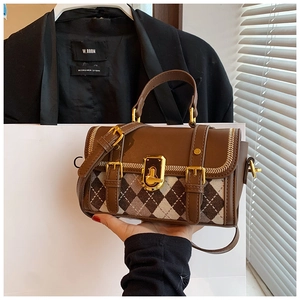 Close-up of retro brown argyle pattern cross-body bag with golden twist lock