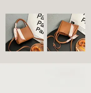Vue détaillée du sac à main en cuir marron grainé avec poignée en foulard de soie