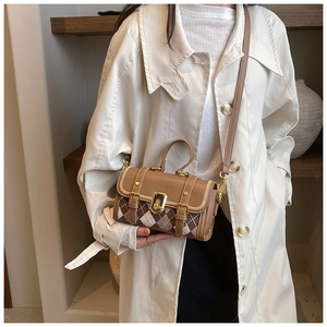 Close-up of a brown patchwork crossbody bag featuring vintage plaid fabric and gold hardware