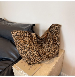 Detail of canvas tote bag with brown leopard print and metal snap button closure