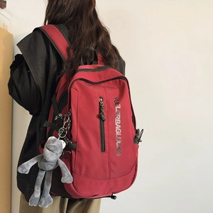 Large dark red school backpack with plush monkey charm for students and travel