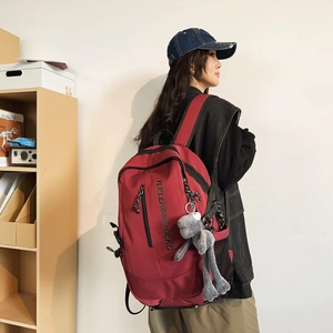 Deep red high-capacity backpack for students with plush pendant and side mesh pockets