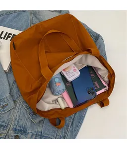 Detailed interior of caramel brown tote bag showing spacious capacity and zipper pocket
